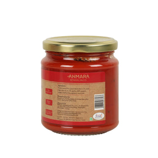 Jar of tomato sauce with a gold lid on a white background